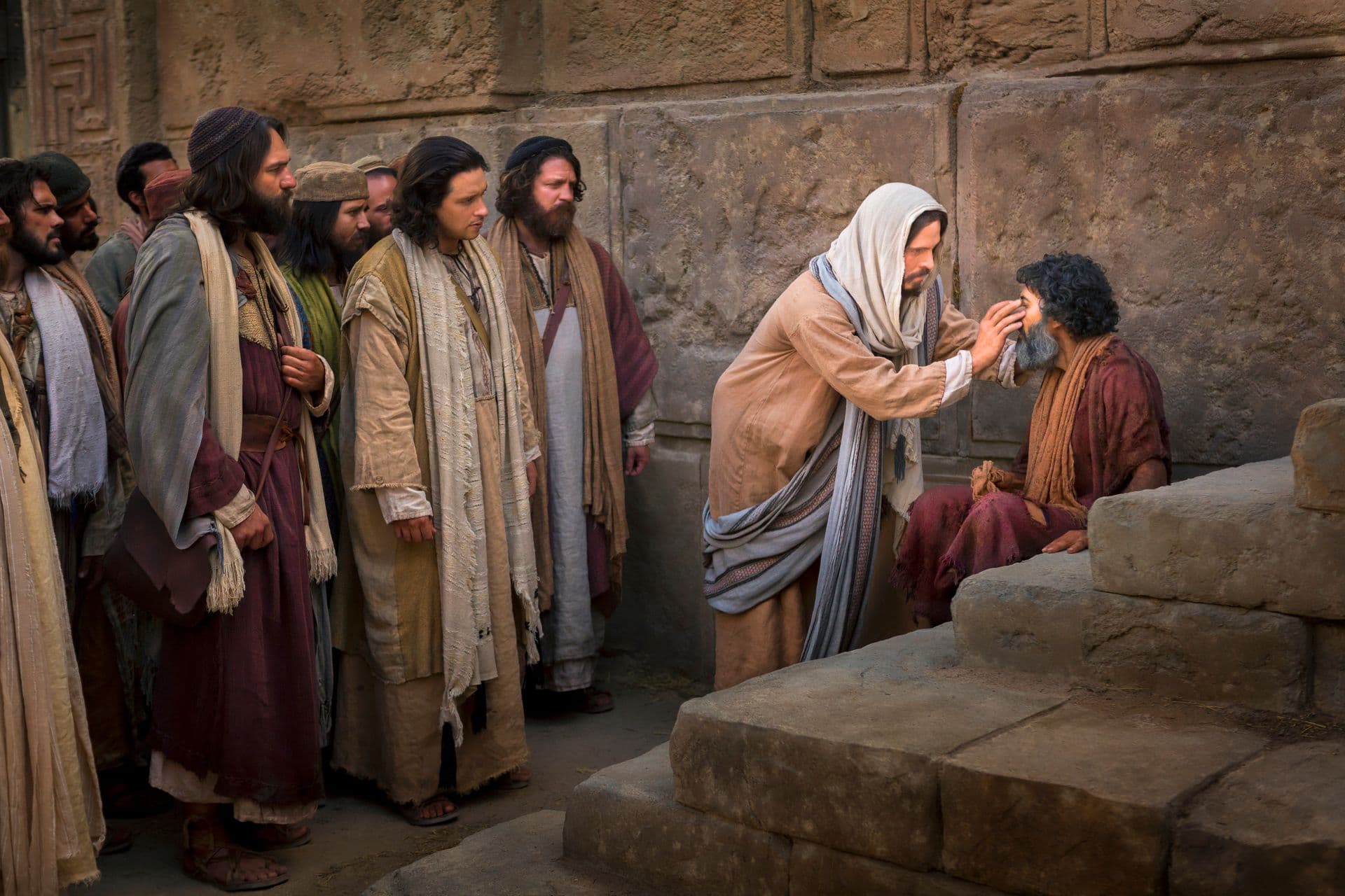 Jesucristo inclinándose para tocar los ojos de un hombre sentado mientras sus discípulos observan junto a un muro de piedra.
